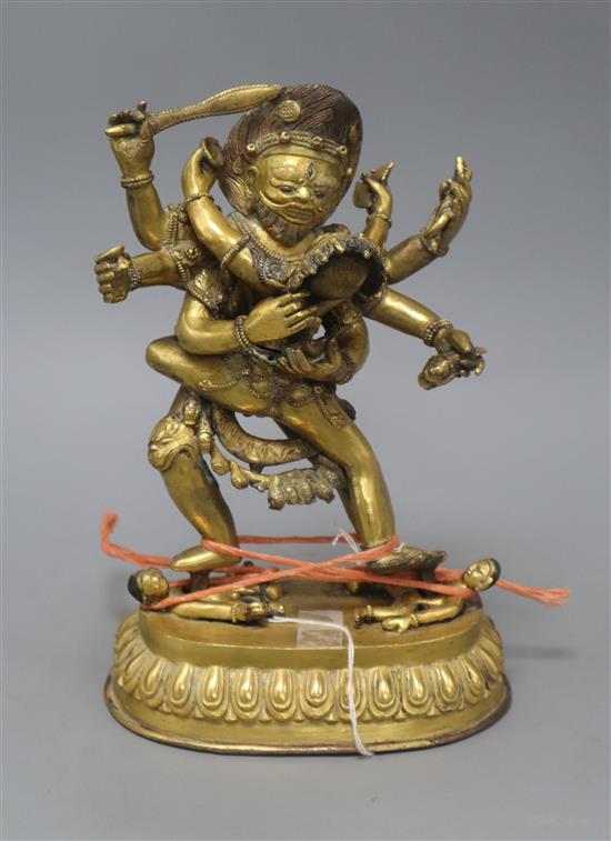 A Tibetan gilt bronze group of Mahakala, height 26cm